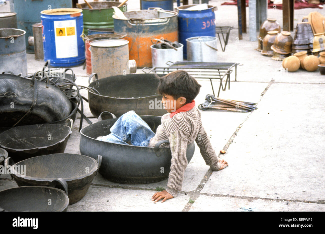 Small boy sitting in basket made from a recycled car tire. Stock Photo