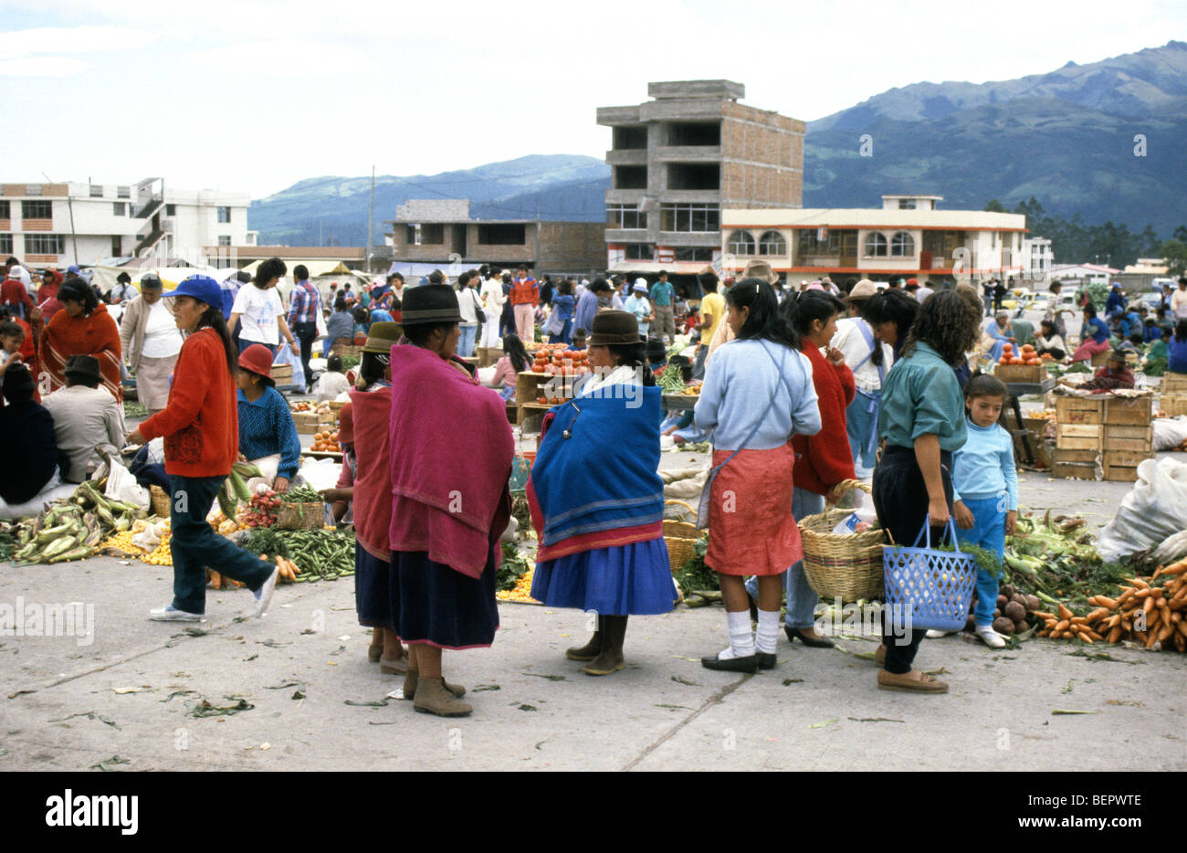 Three women in traditional inca dress in local upland Ecuador market. Stock Photo