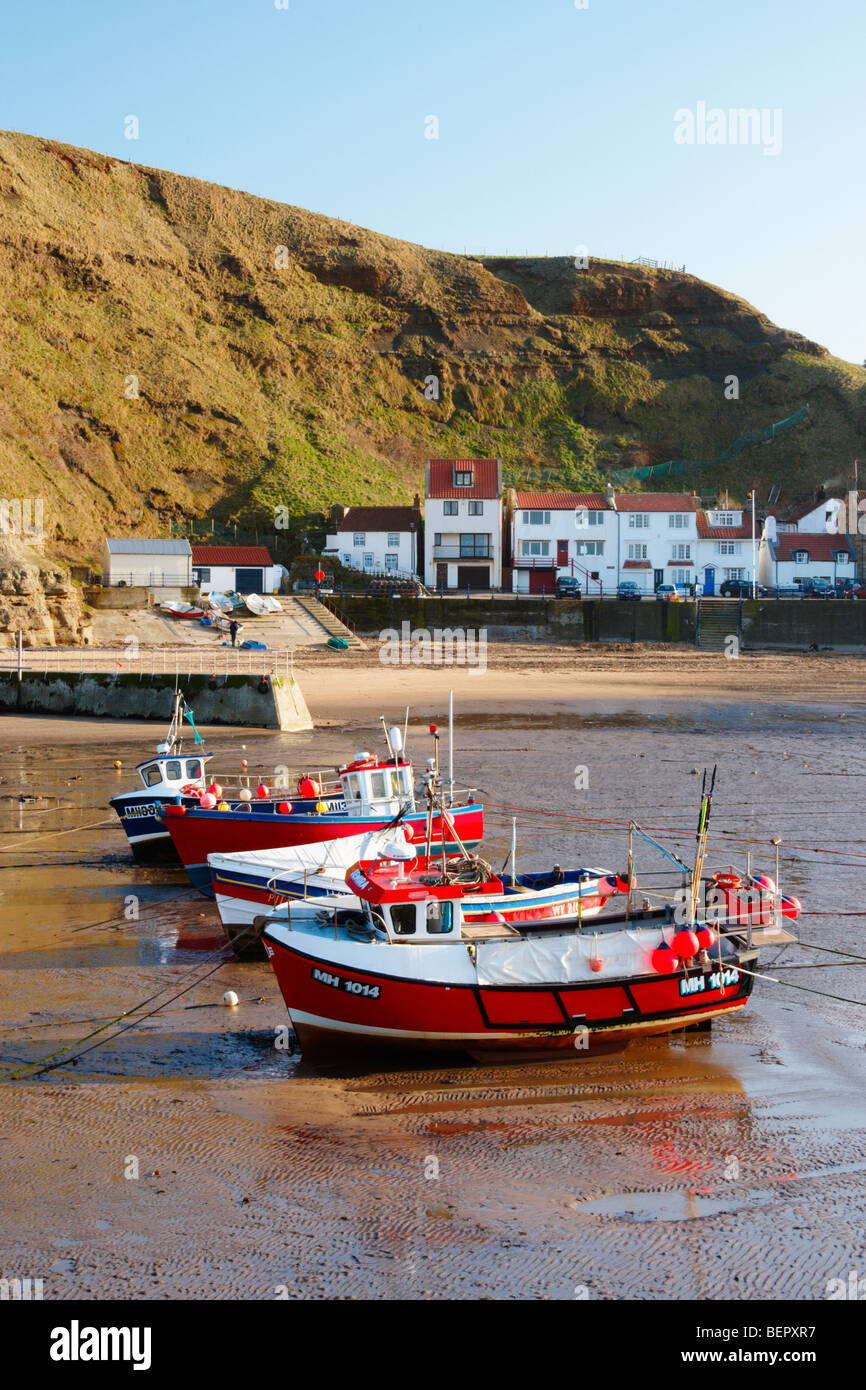 Fishing boats at low tide in Staithes village on the North Yorkshire ...