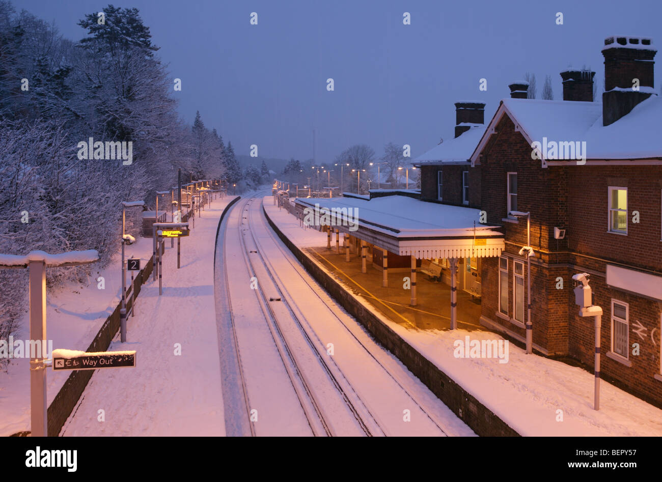 Otford railway station in winter snow at dusk, no trains ran that day. There's even snow on the railway lines Stock Photo