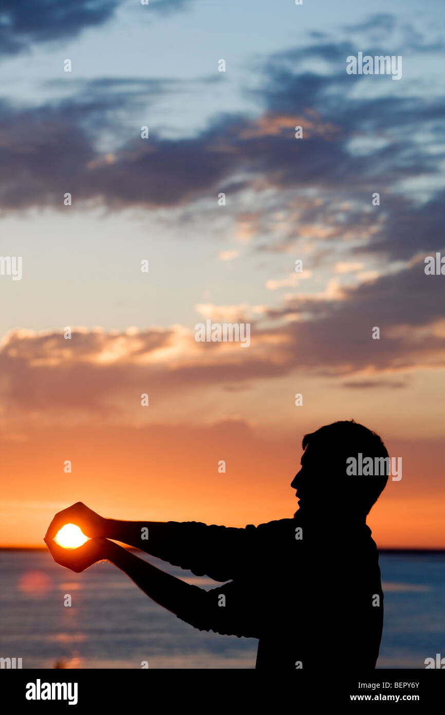 Person holding the sun. Stock Photo