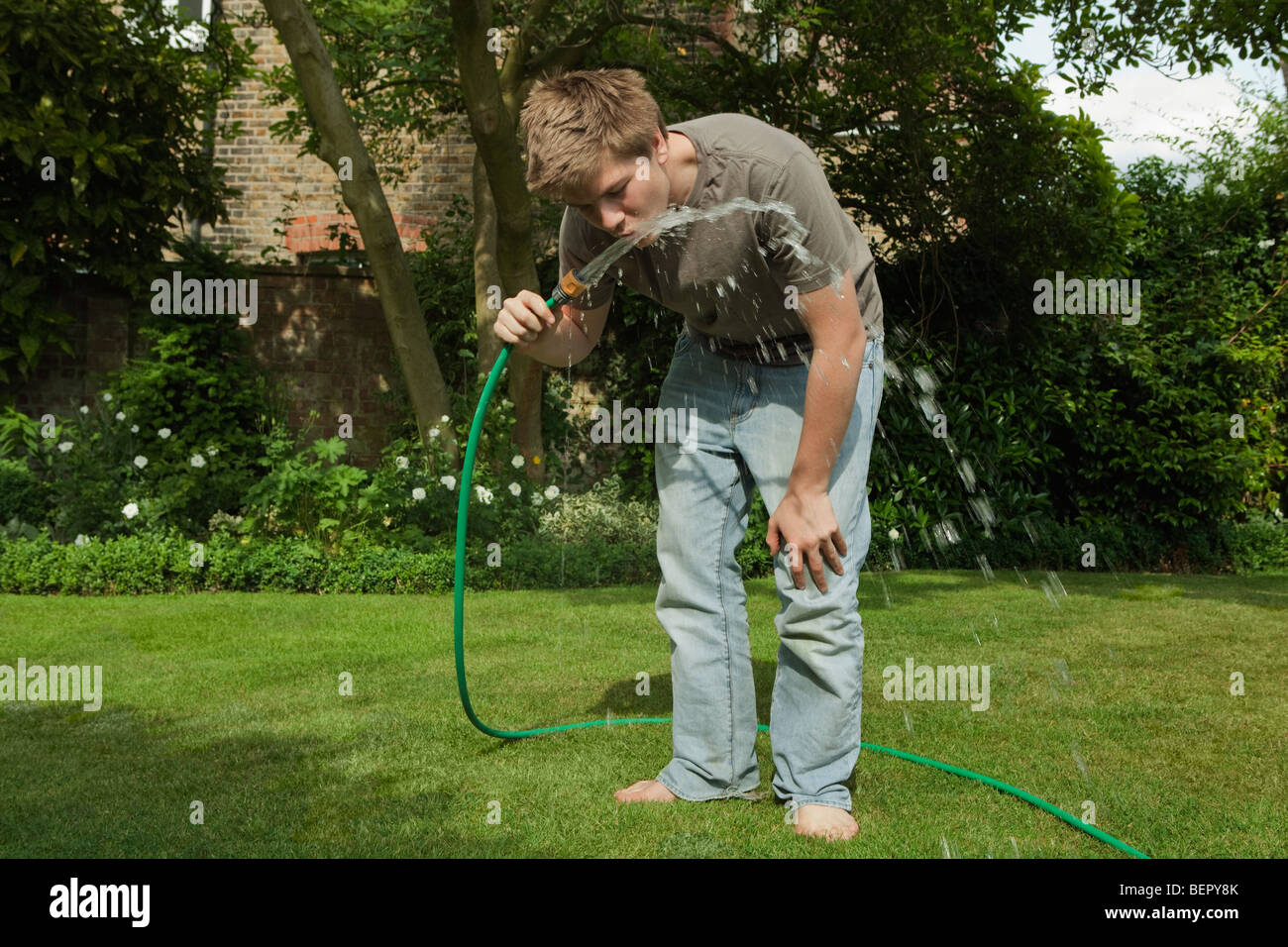 Children drinking from water hose hires stock photography and images Alamy