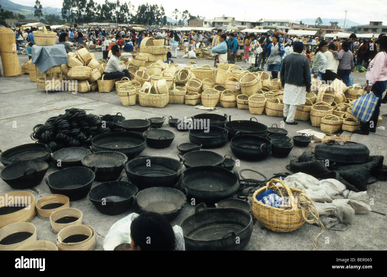 Basket sellers in Ecuador market.  Wicker and black ones made from recycled car tires Stock Photo