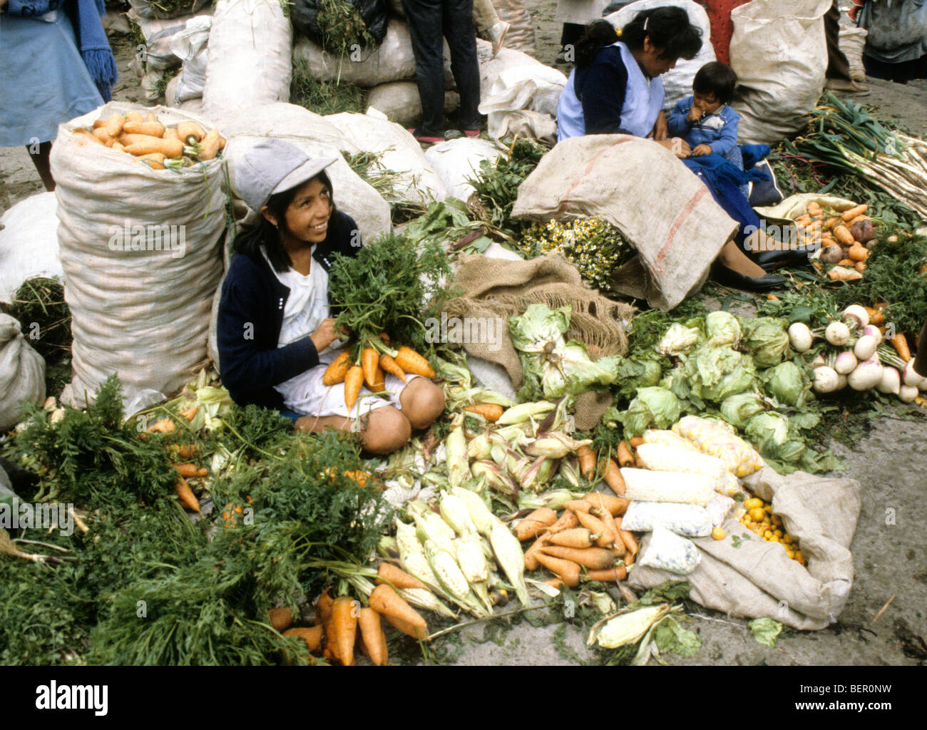 Young girl selling vegetables in local upland Ecuador market. Stock Photo