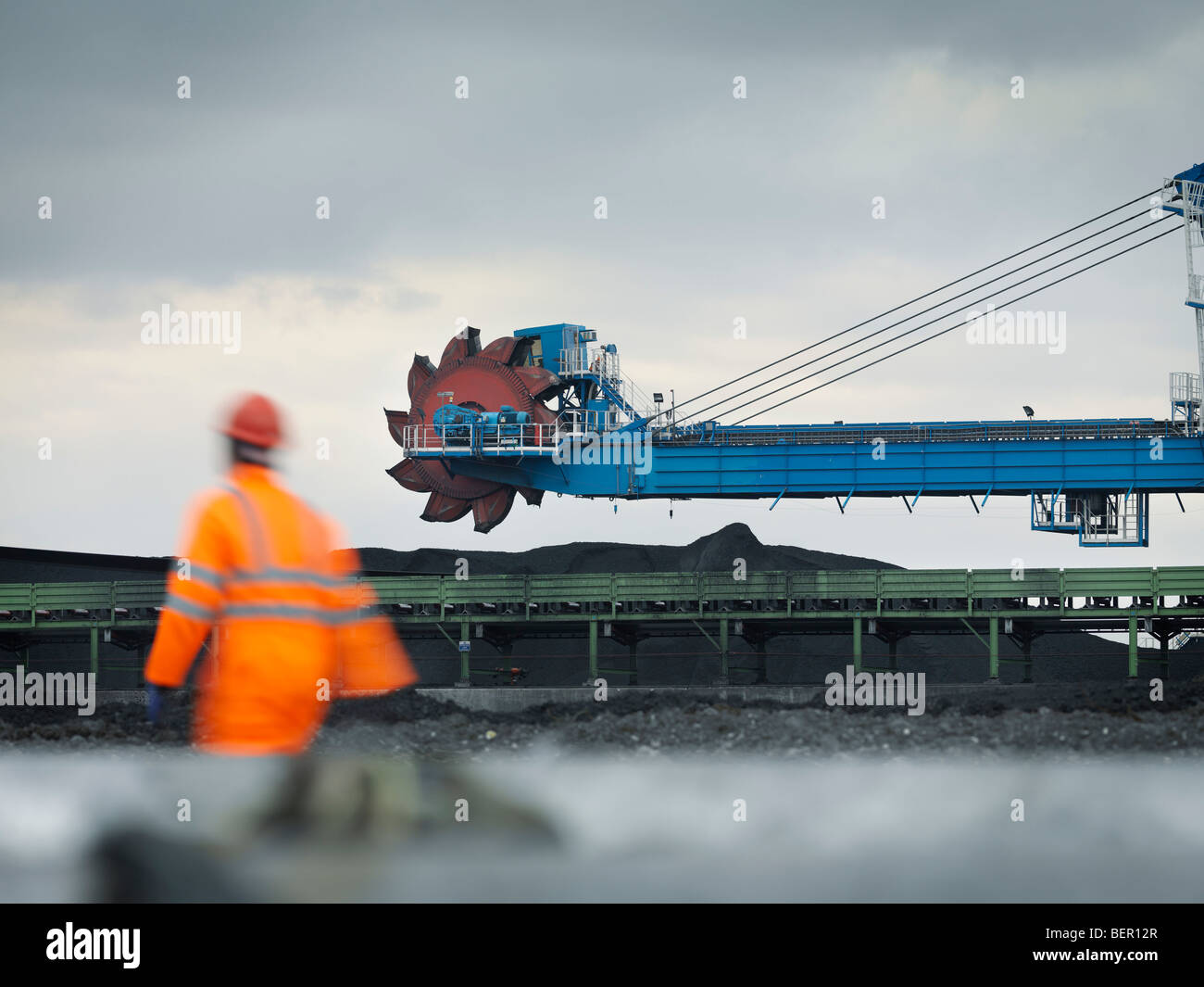 Port Worker With Heavy Machinery Stock Photo