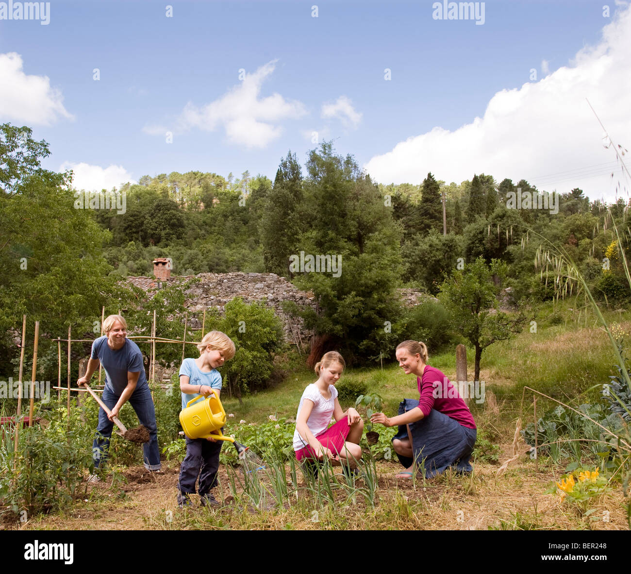 family of four gardening Stock Photo Alamy