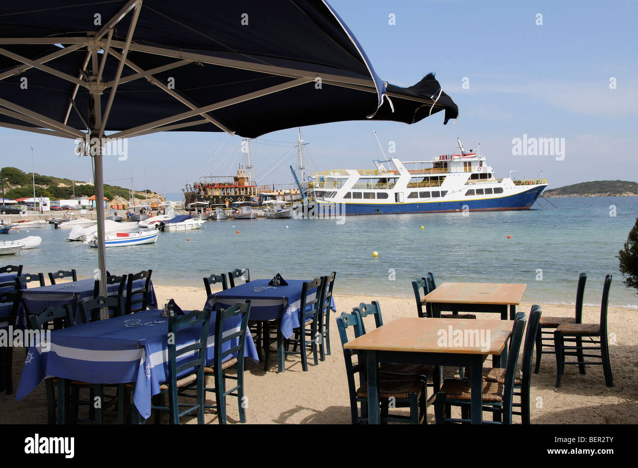 Empty tables at a seafront restaurant in Ormos Panagias northern Greece Stock Photo