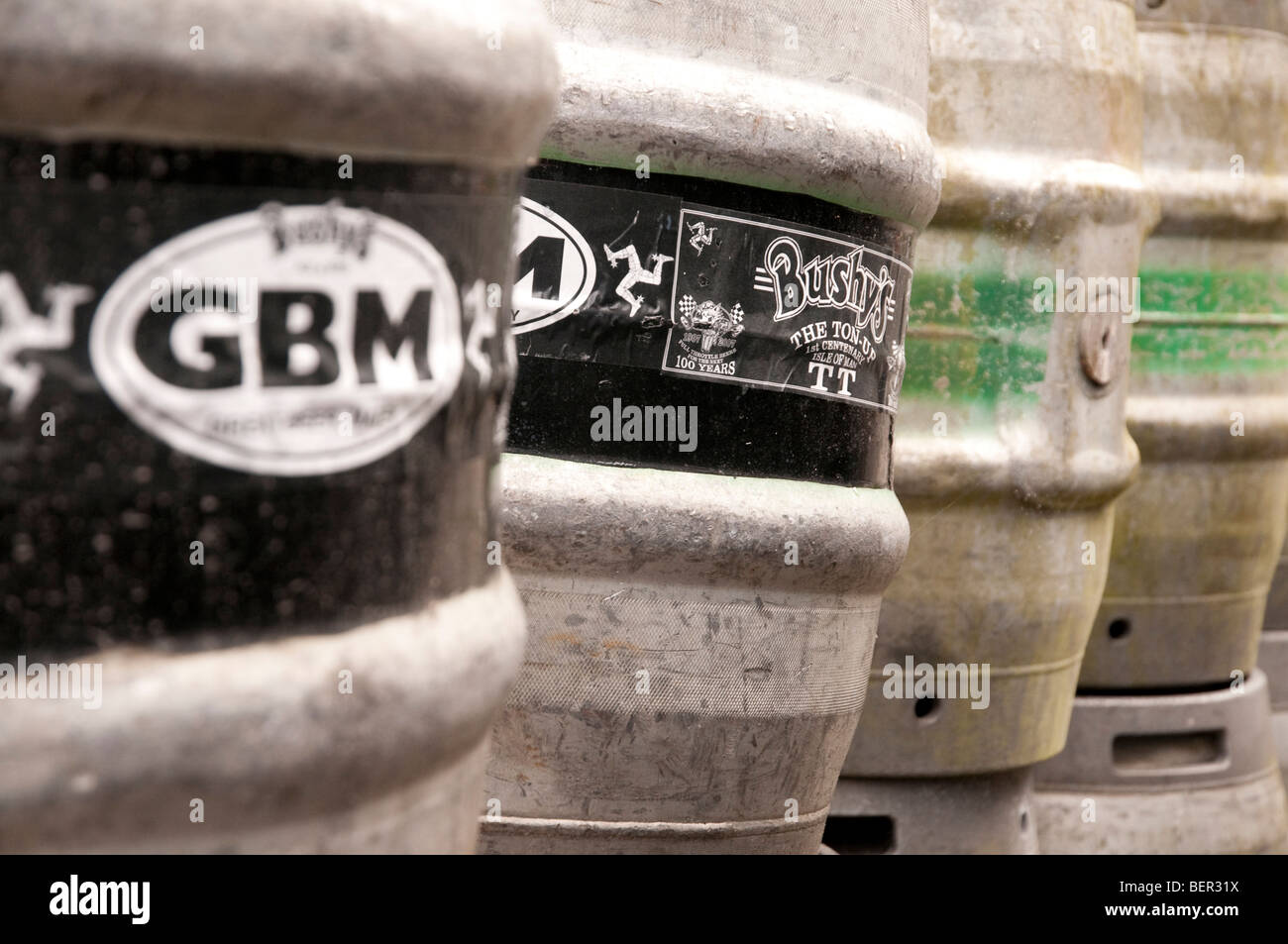 Line of Bushy's brewery casks outside the brewery in the isle of man, with branding and brewery name visible. Stock Photo