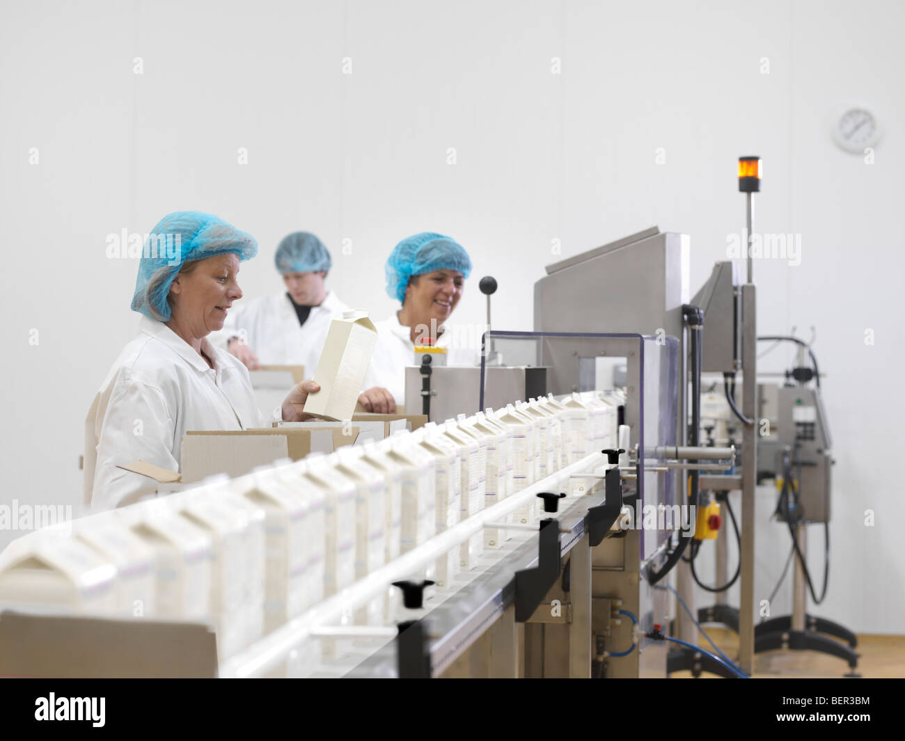 Food Workers On Production Line Stock Photo