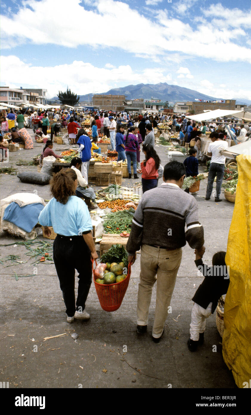 Market goes share carrying produce in  local market  upland Ecuador Stock Photo