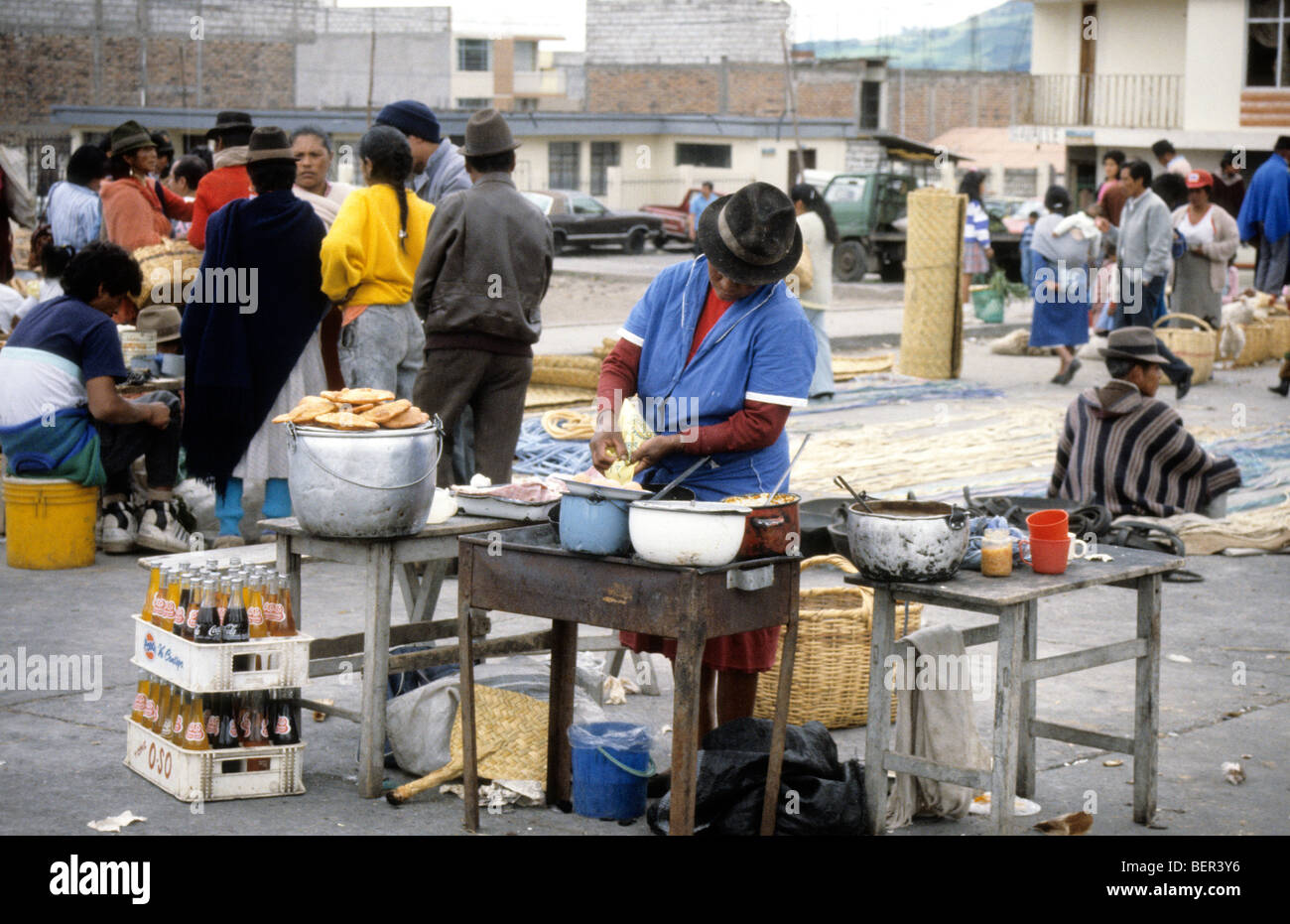 Prepared food seller in local upland ecuador market makes a new batch of pancake like foods. Stock Photo
