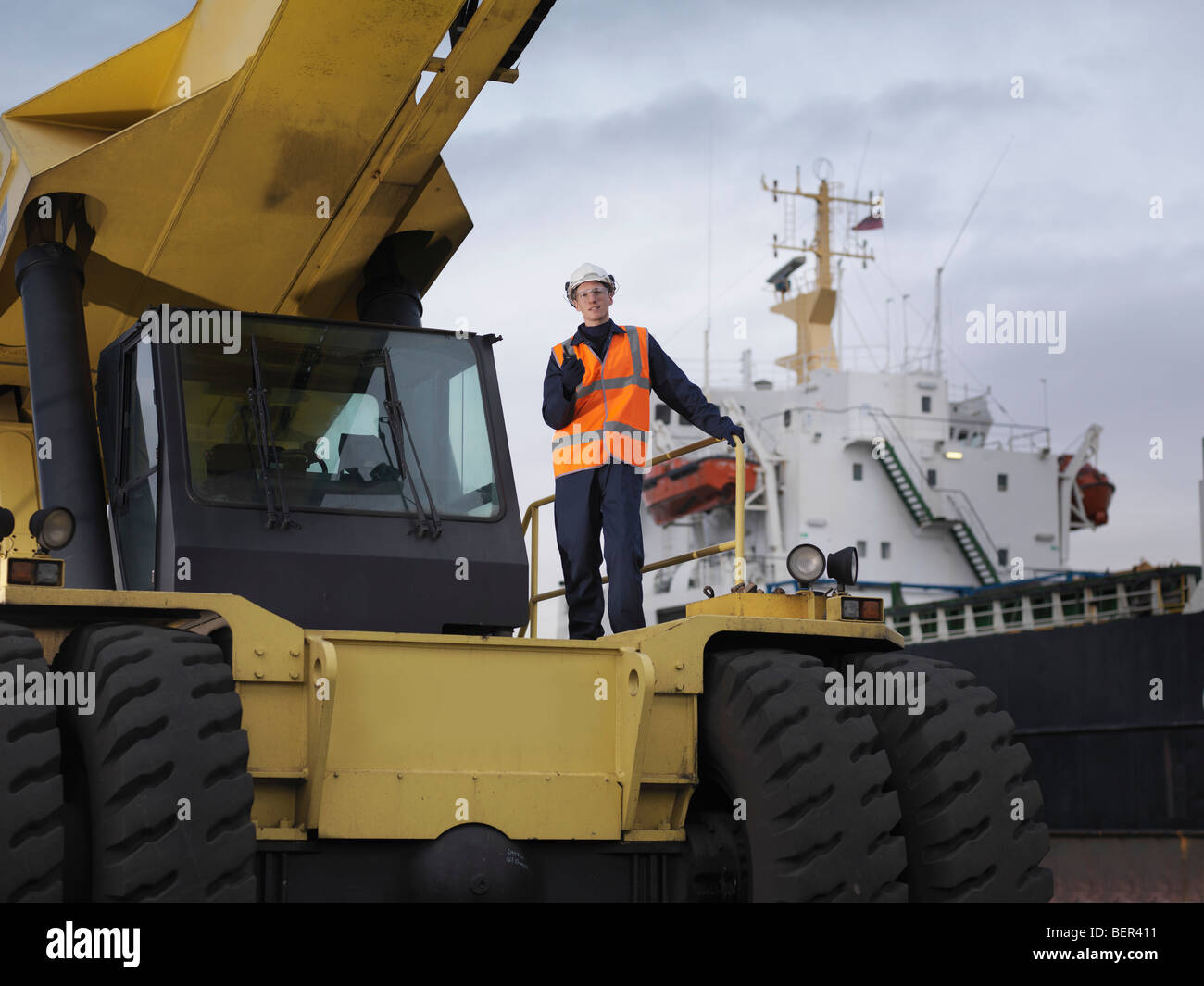Port Worker Standing On Container Grab Stock Photo