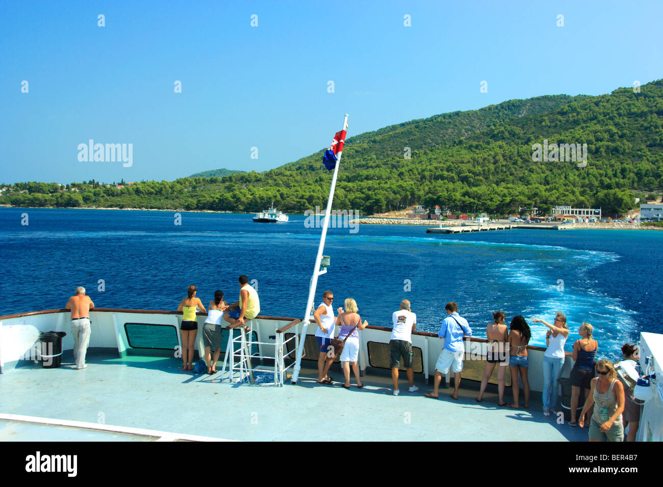 People watching Stari Grad harbour as the ferry leaves for Split ...