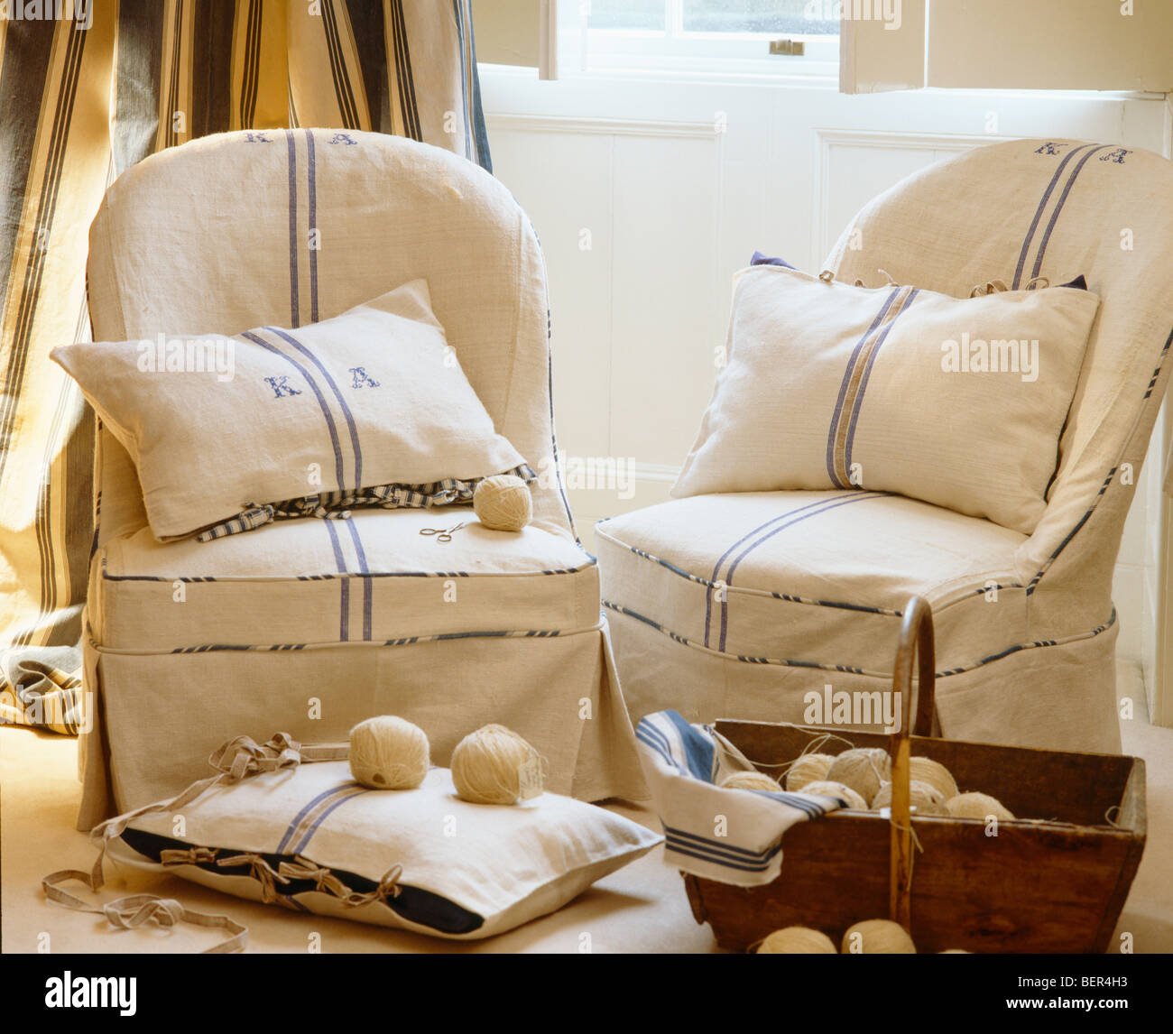 Closeup of armchairs with loosecovers and cushions made from rough