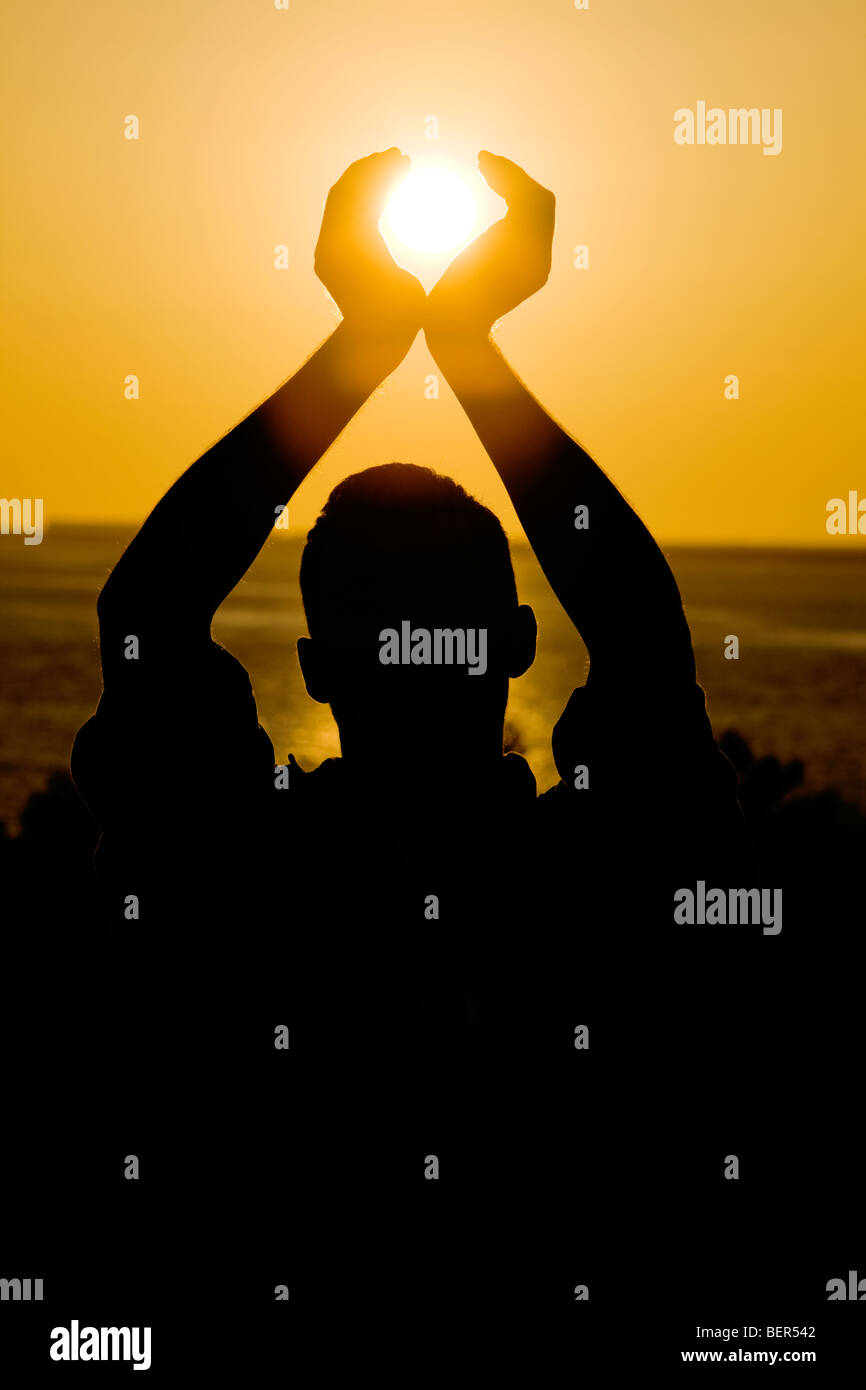 Person holding the sun. Stock Photo