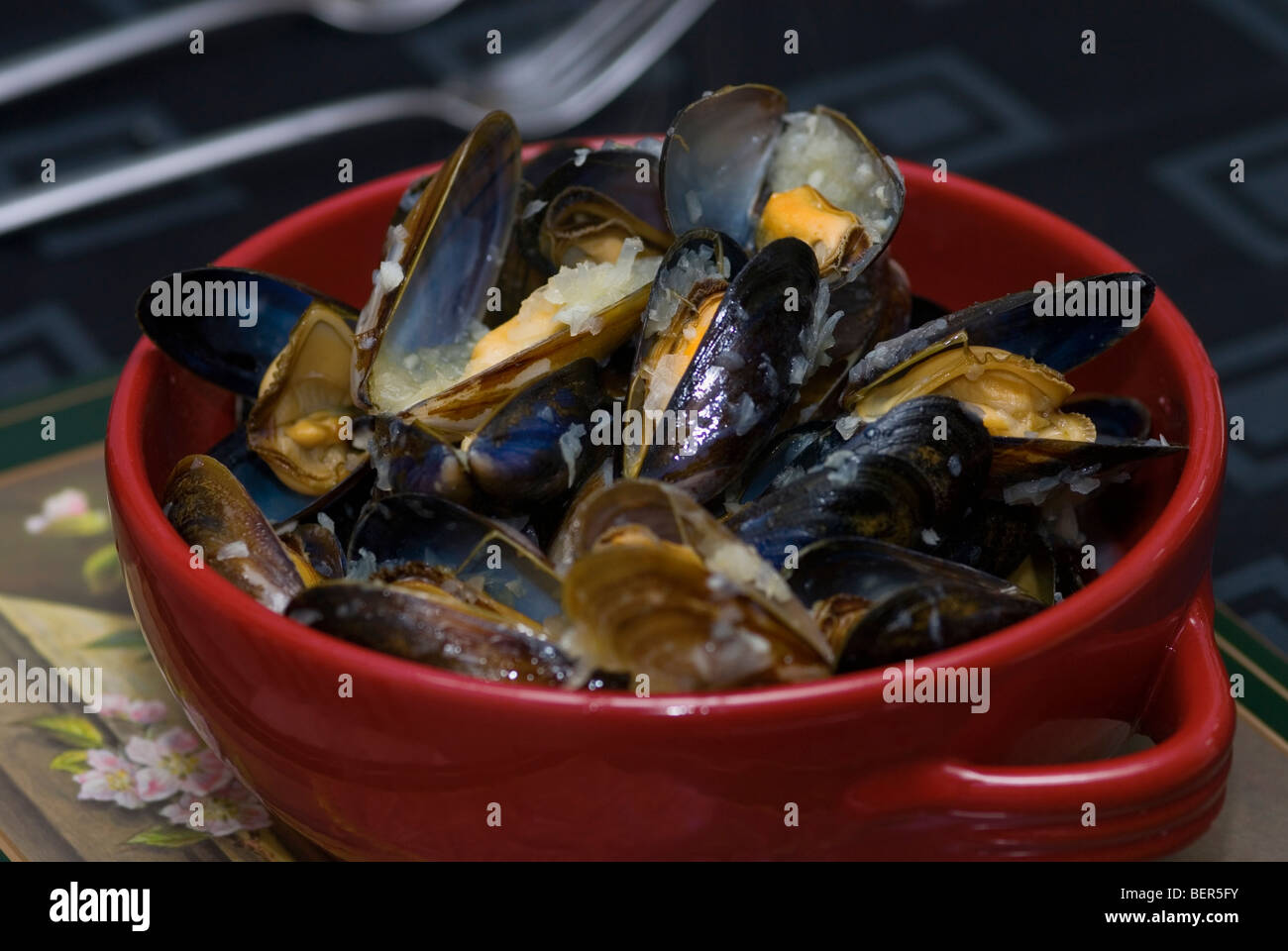 Cooked Mussels in red bowl Stock Photo