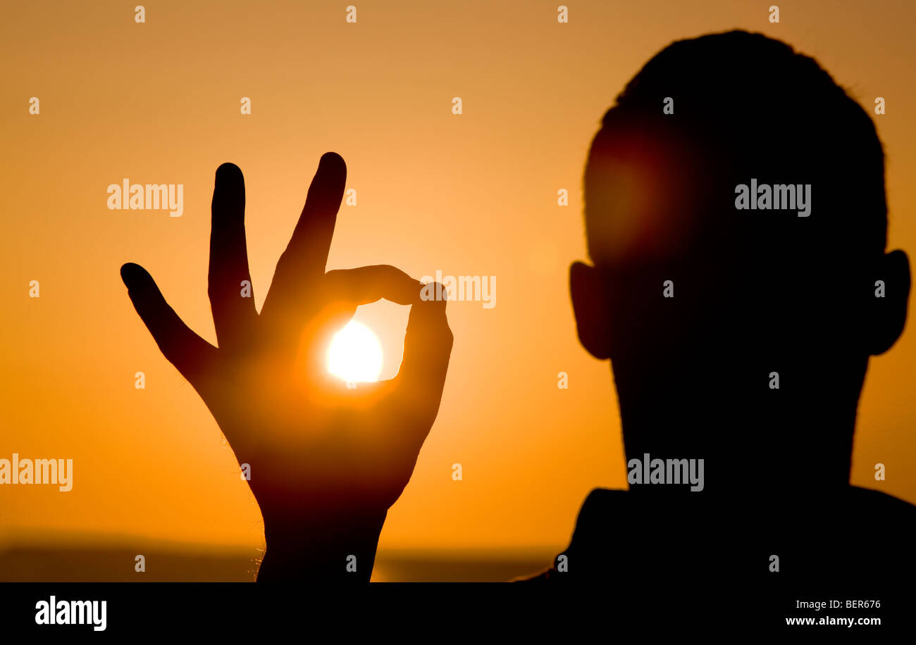 Person holding the sun. Stock Photo