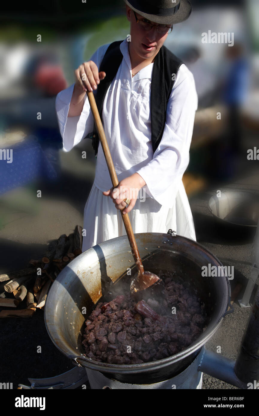 Young man wearing traditional costume Bugac Pusza preparing Goulash - Gyor Gastronomic Festival Hungary Stock Photo