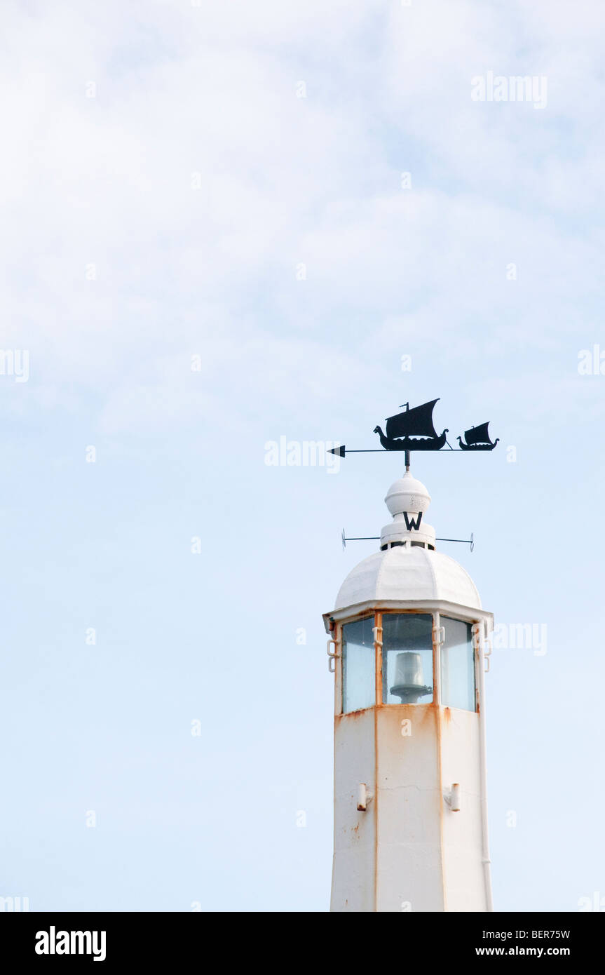 Top of a small lighthouse at Peel harbour in the Isle of Man, with Viking longship wind vane. Stock Photo
