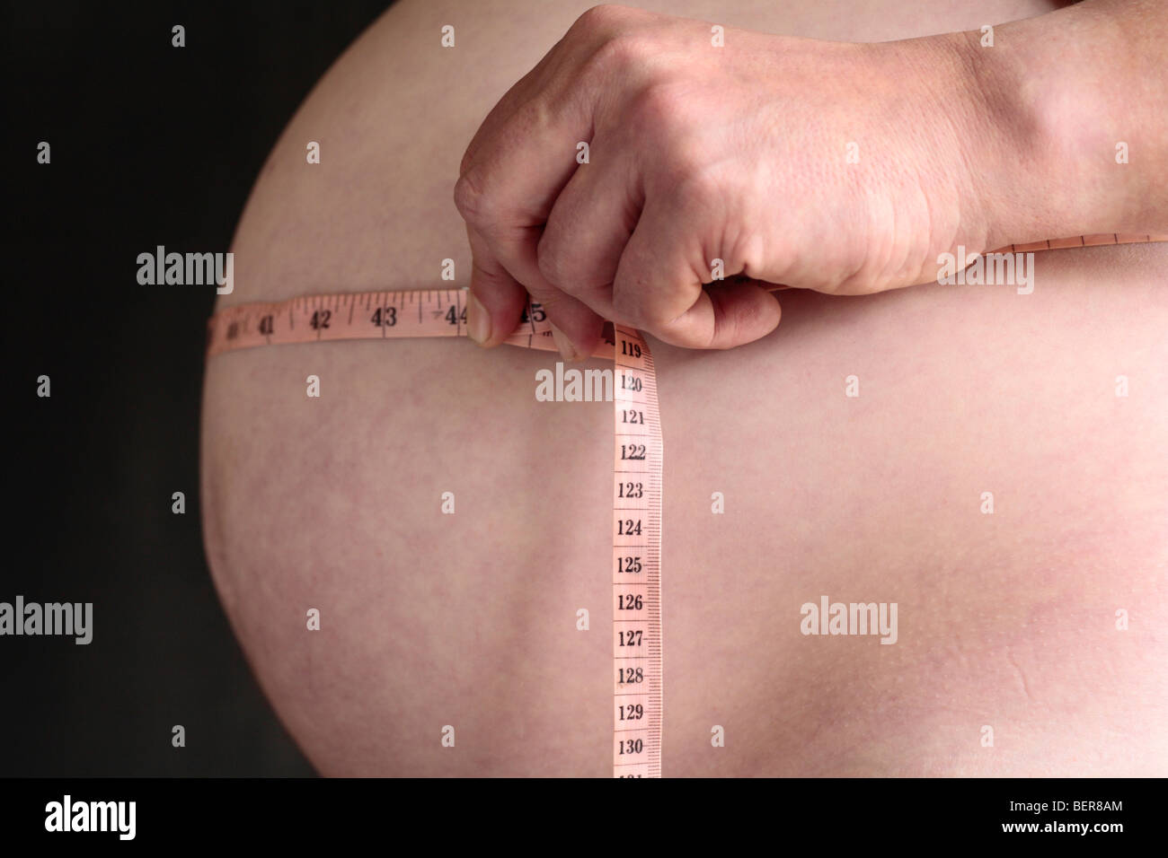 Tape measure around the abdomen of an overweight male. Stock Photo