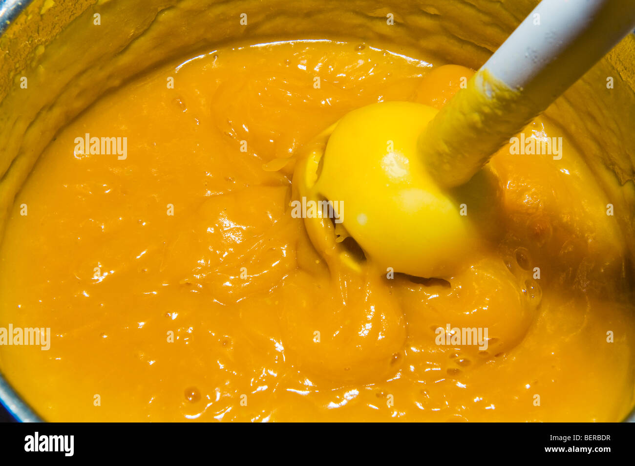 hot make pumpkin soup pot mixer puree strain pureeing straining kitchen  produce production make immersion blender Stock Photo - Alamy