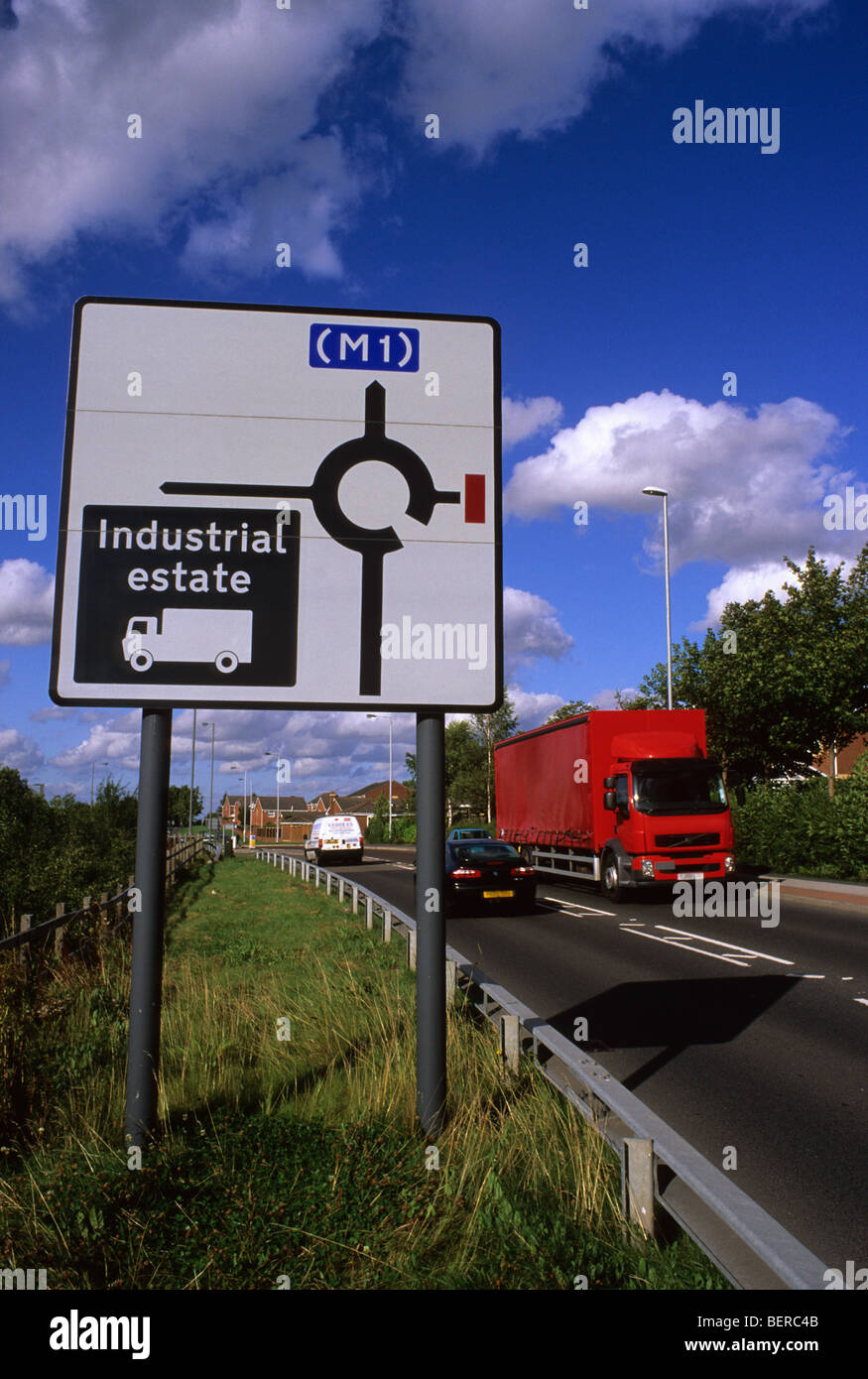 articulated lorry passing road sign giving directions for lorry drivers