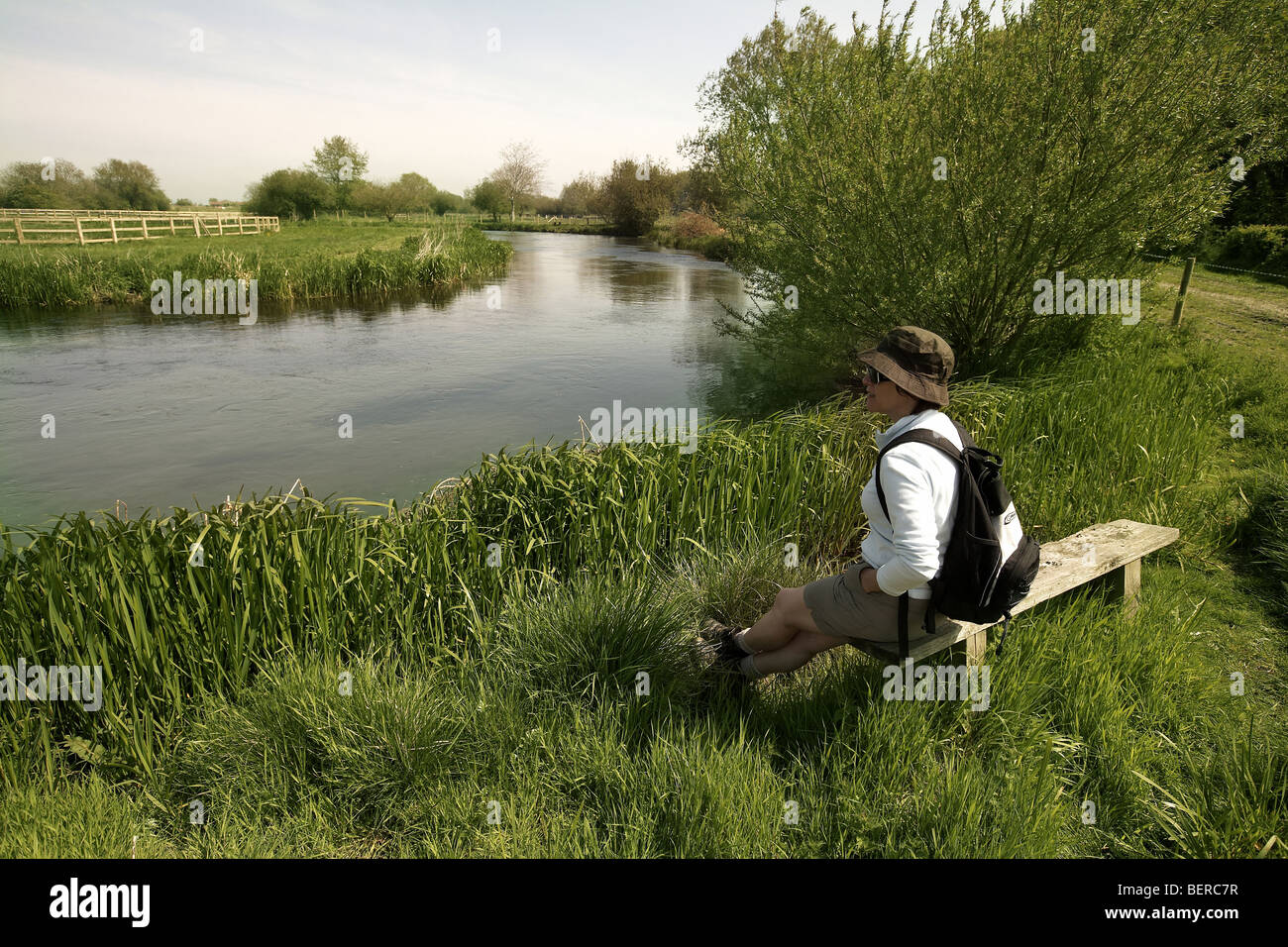 Walker on West Beck chalk stream river, Wansford, Driffield, East Yorkshire, UK Stock Photo