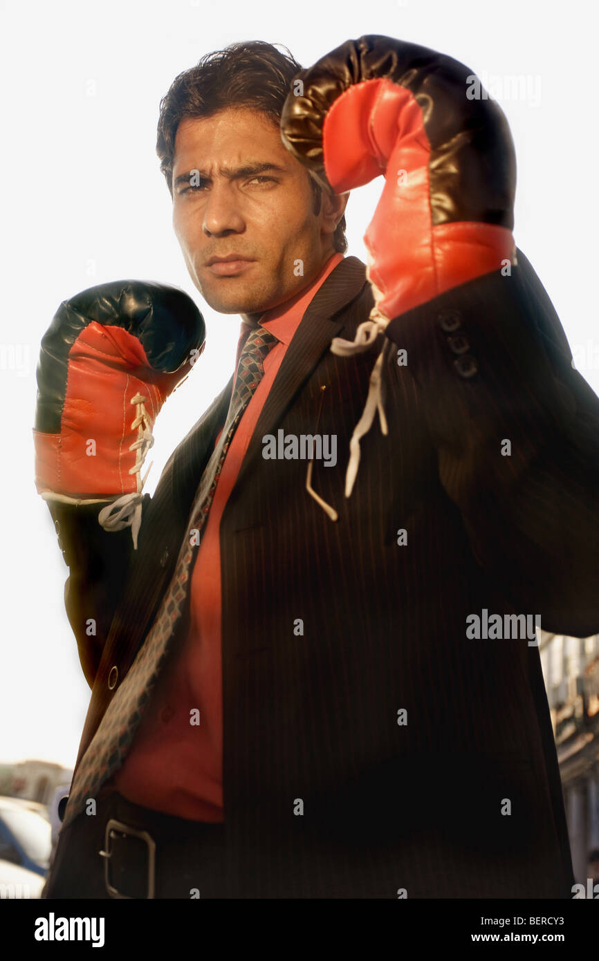 Businessman wearing boxing gloves Stock Photo Alamy