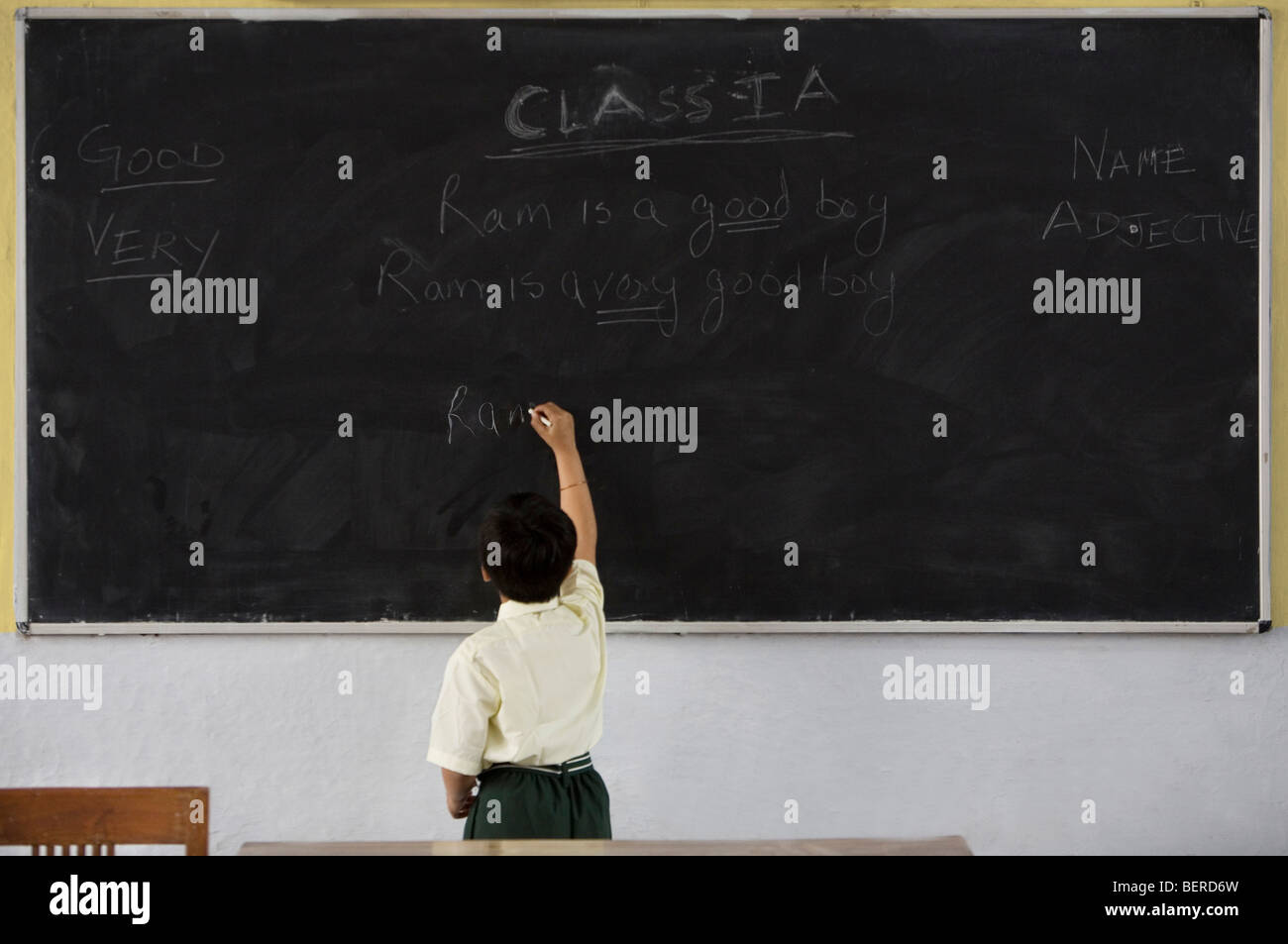 Boy writing on a black board Stock Photo