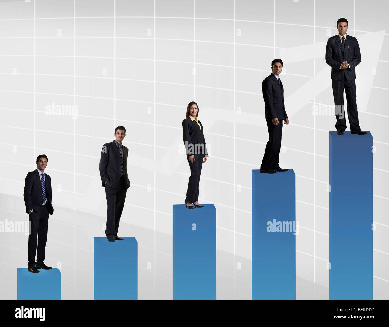 Businesspeople standing on a graph Stock Photo