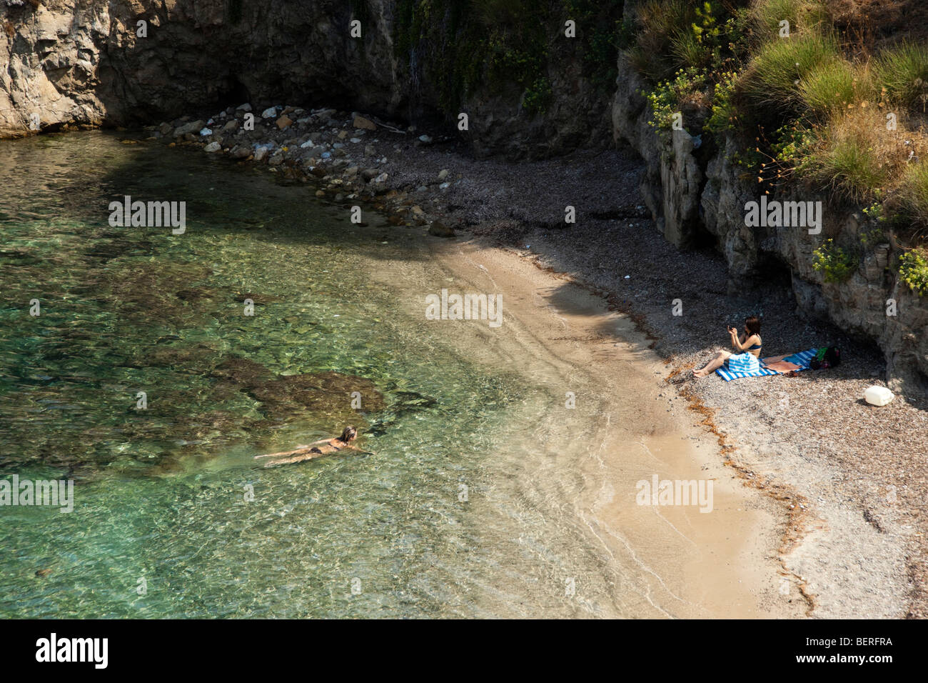 Assos village Kefalonia with swimmers bay and sea Stock Photo