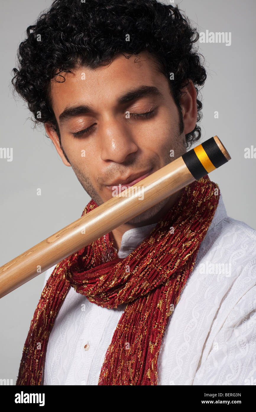 Man playing wood wind instrument hires stock photography and images