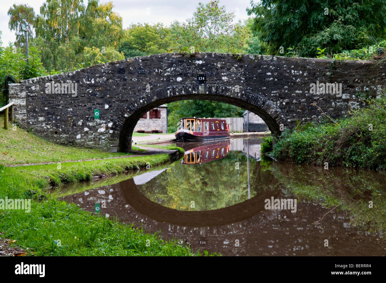 Old stone bridge 134 on the Monmouth and Brecon Canal taken at Llangynidr mid Wales early autumn with perfect still reflection Stock Photo