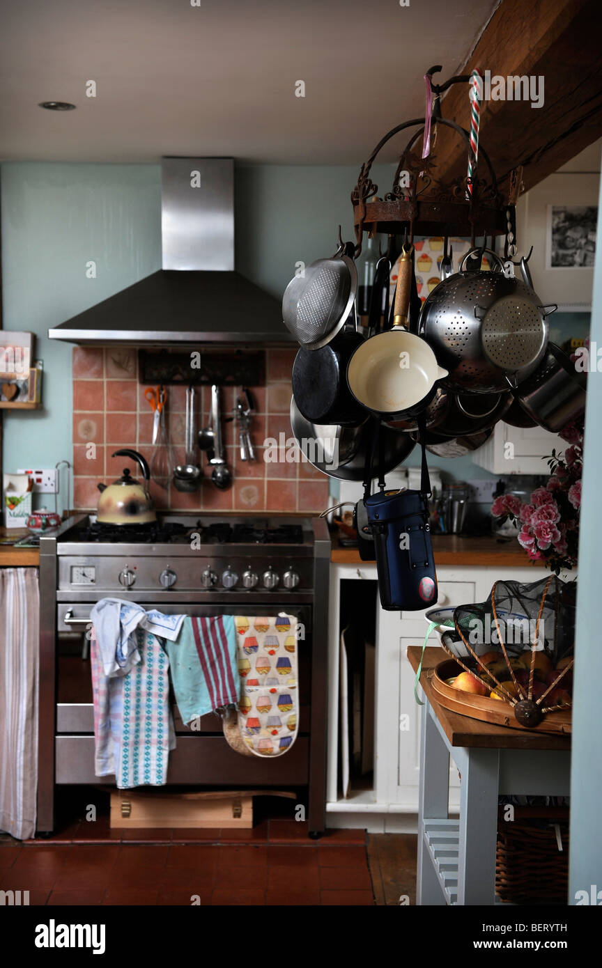KITCHEN WITH UTENSILS HANGING FROM A BEAM IN A COUNTRY COTTAGE UK Stock Photo