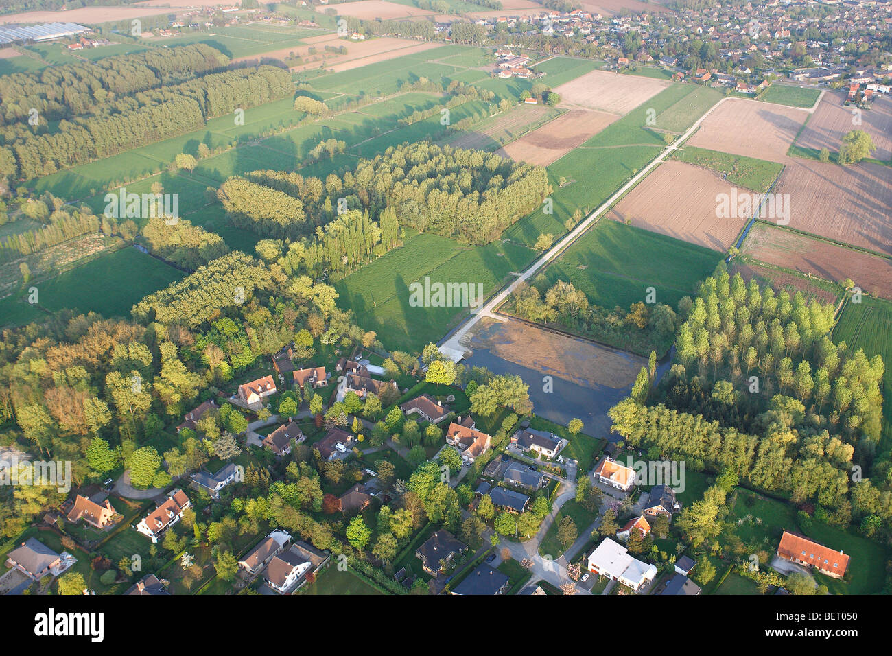 Urbanisation at the border of agricultural area with fields, grasslands and hedges from the air, Belgium Stock Photo