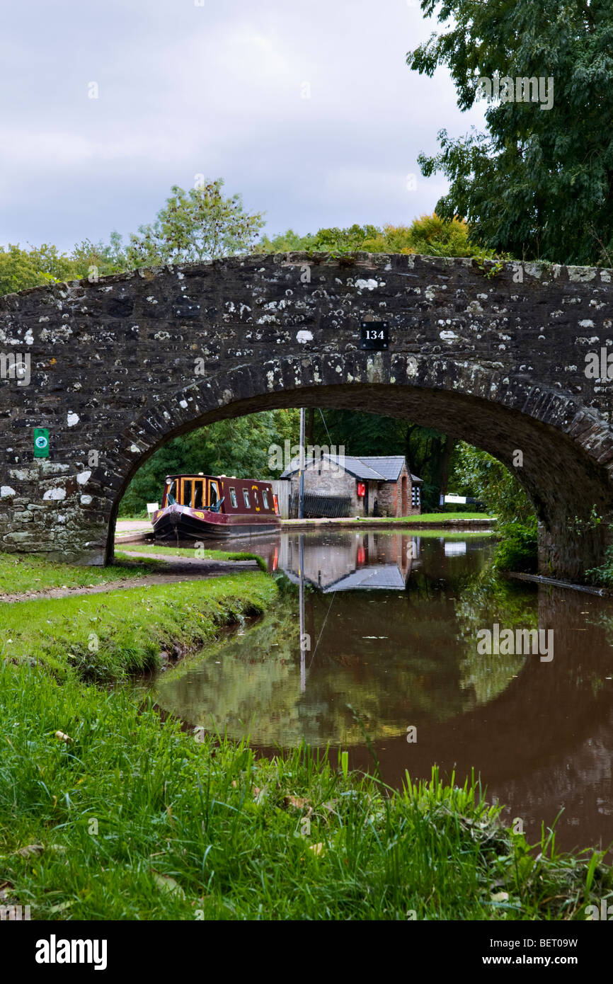 Old stone bridge 134 on the Monmouth and Brecon Canal taken at Llangynidr mid Wales early autumn with pretty reflection Stock Photo