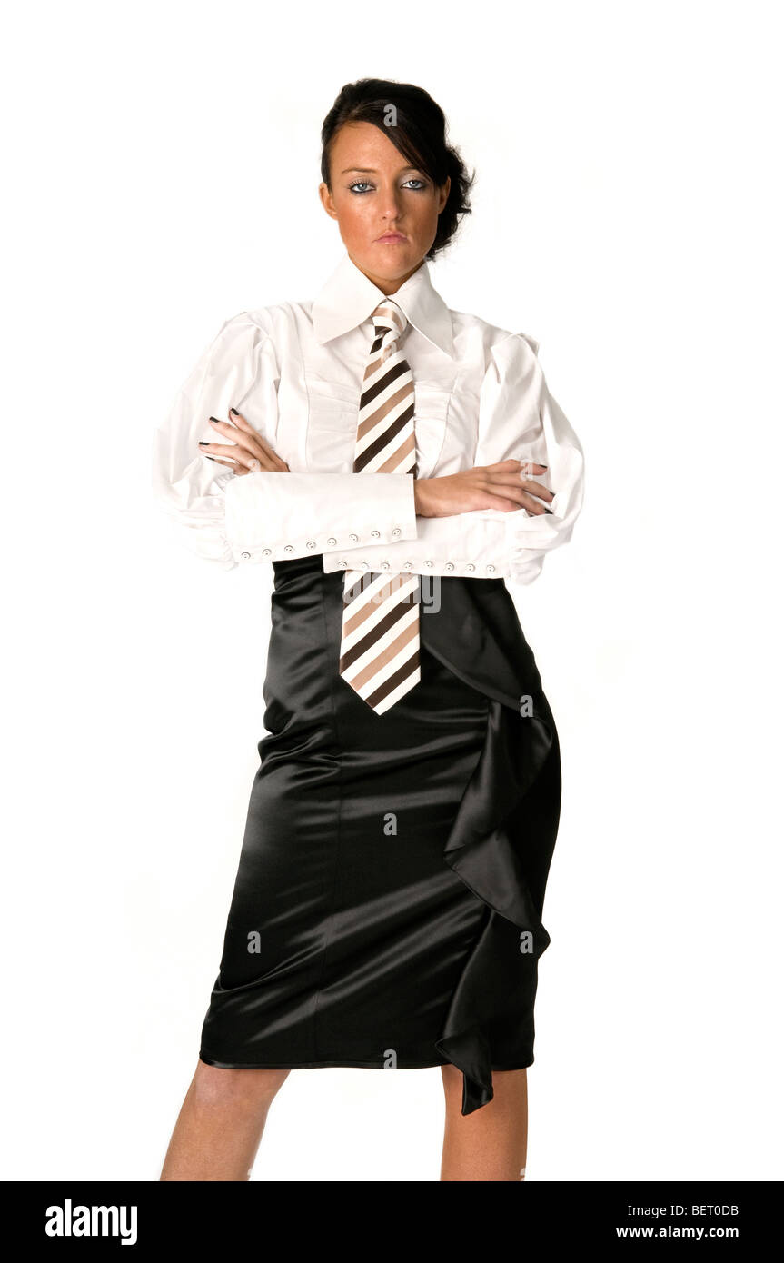 Female secretary arms folded looking stern / annoyed wearing white shirt  and black skirt against white . FULLY MODEL RELEASED Stock Photo - Alamy