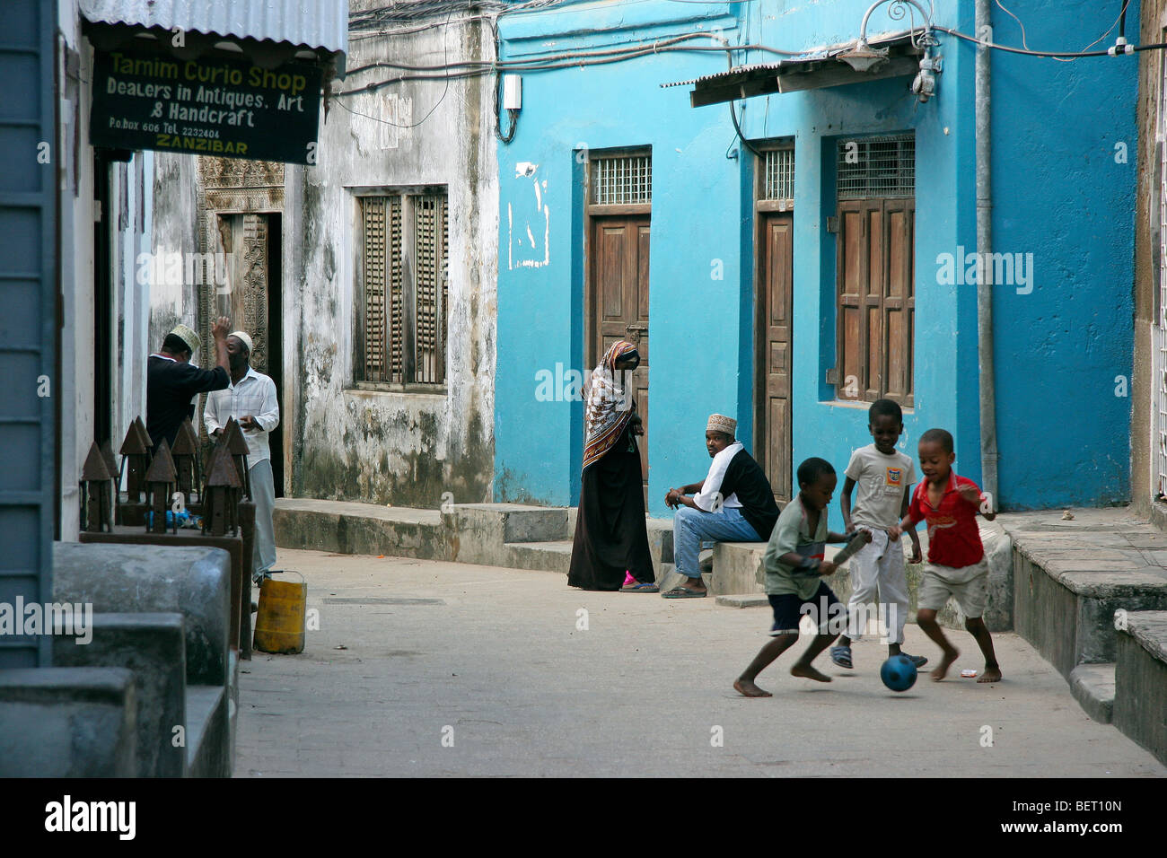 Black children playing in alley of the old medina of Stone Town / Stonetown / Mji Mkongwe, Zanzibar, Tanzania, East Africa Stock Photo