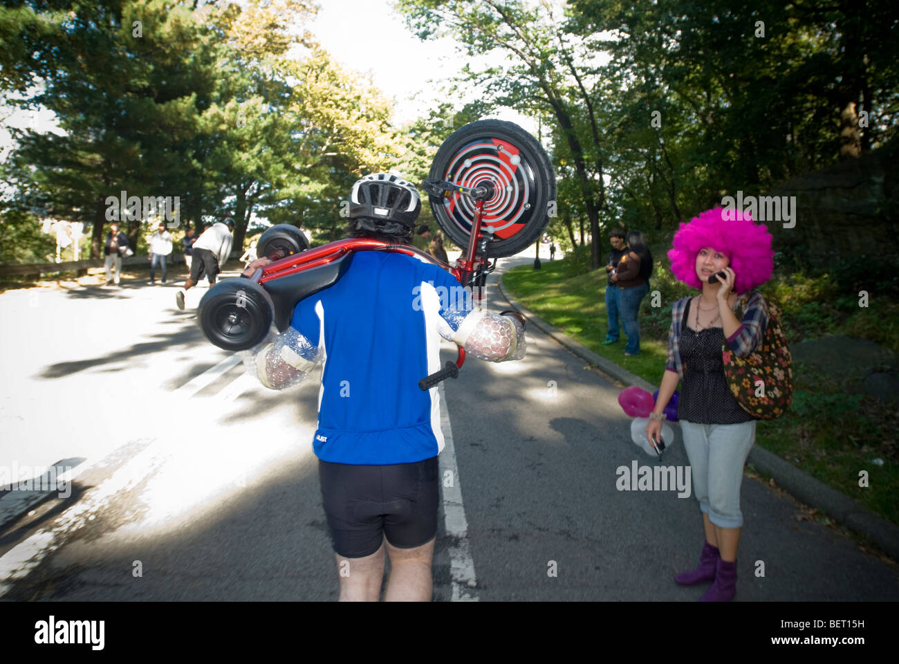 Participants in the 2nd Big Wheel Race in Central Park dangerously hurdle down hills in New York Stock Photo