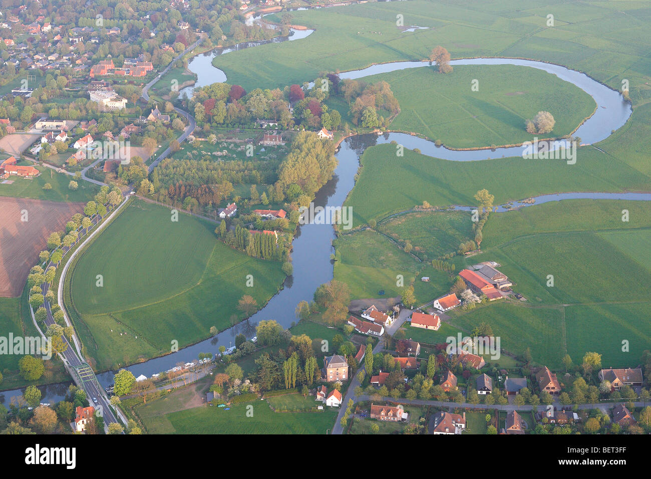 Old meander, grasslands, urbanisation and forested area along river Leie, valley of Leie, Belgium Stock Photo