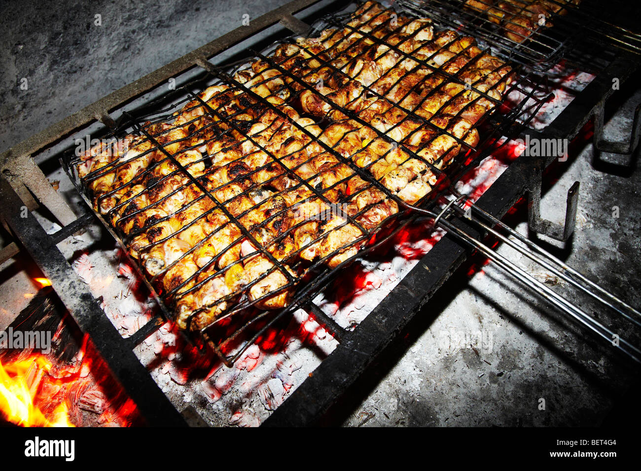 cooking chicken on bar b que fire Stock Photo