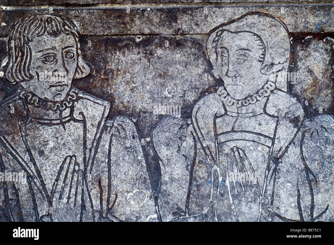 Mediaeval figures on stone tablet at the Gruuthuse museum, Bruges, West Flanders, Belgium Stock Photo