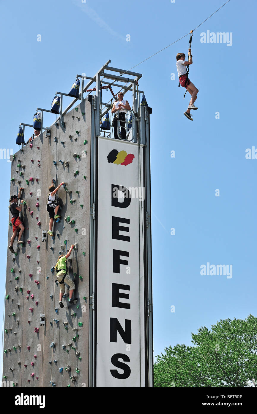 Children on climbing wall and deathride at airshow in Koksijde, Belgium Stock Photo