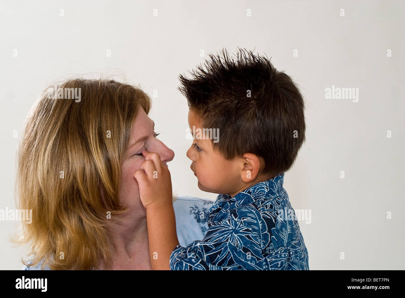 Series images of single mom holding her newly adopted 3 year old Hispanic foster son.Still exploring getting to recognize life change California USA Stock Photo