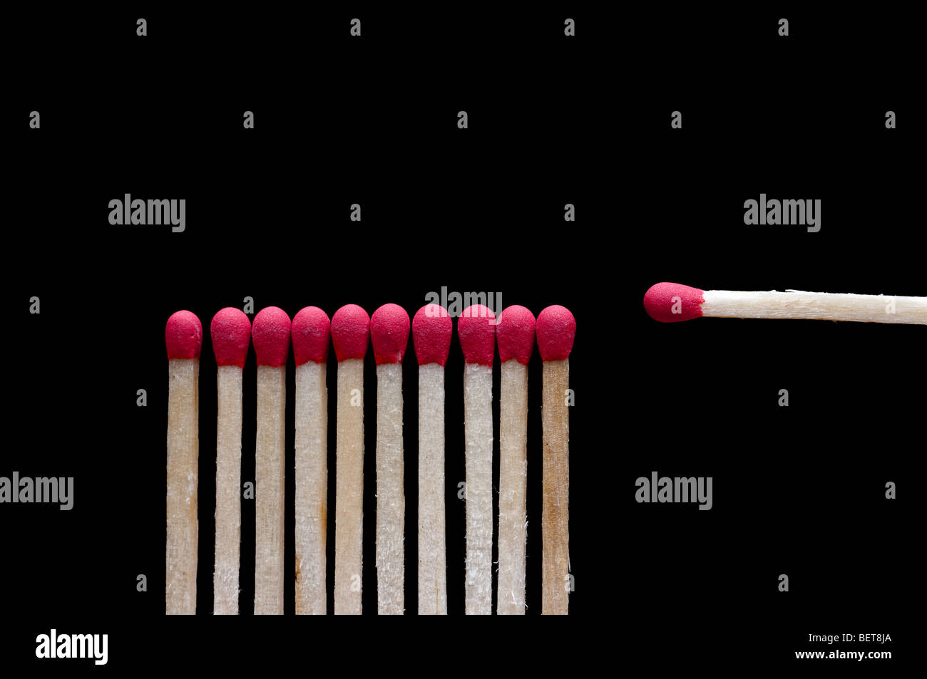 One different wooden match on black Stock Photo