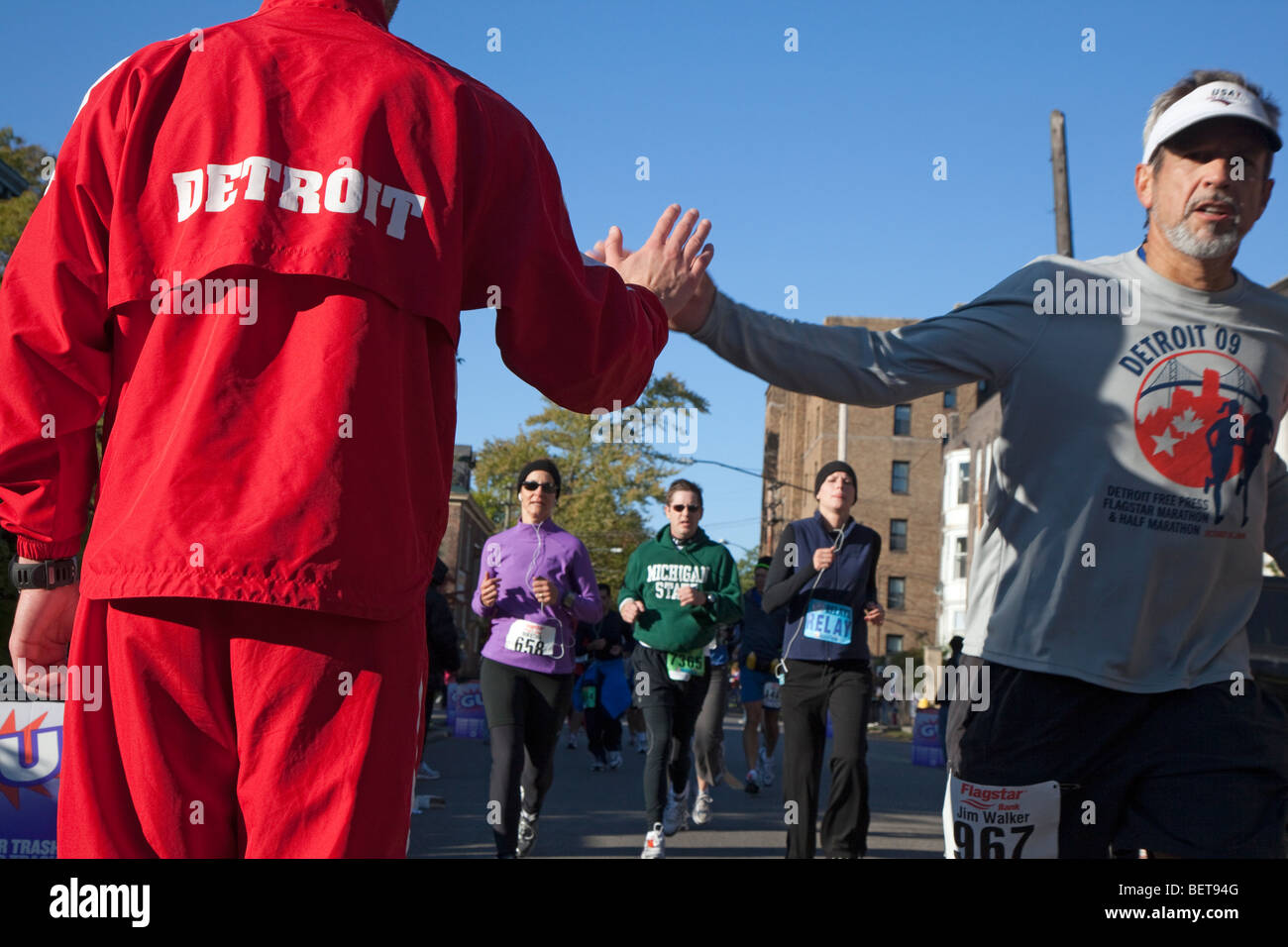 Detroit, Michigan A member of a track club cheers on runners in the
