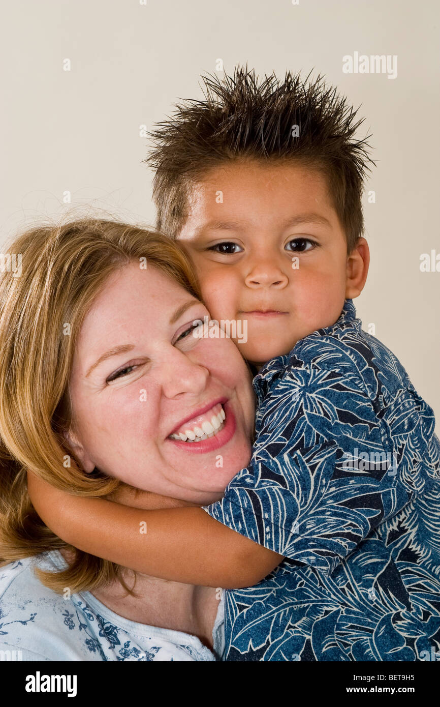 Series of images of a single mom holding her newly adopted 3 year old Hispanic  foster son. California United States  MR Stock Photo