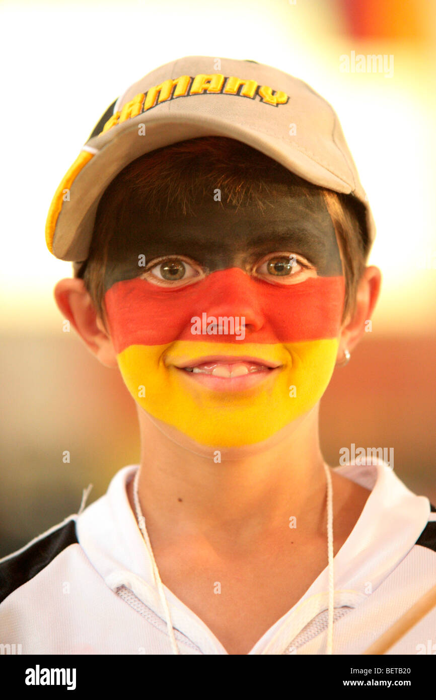 portrait of a young boy with his face painted in the German National