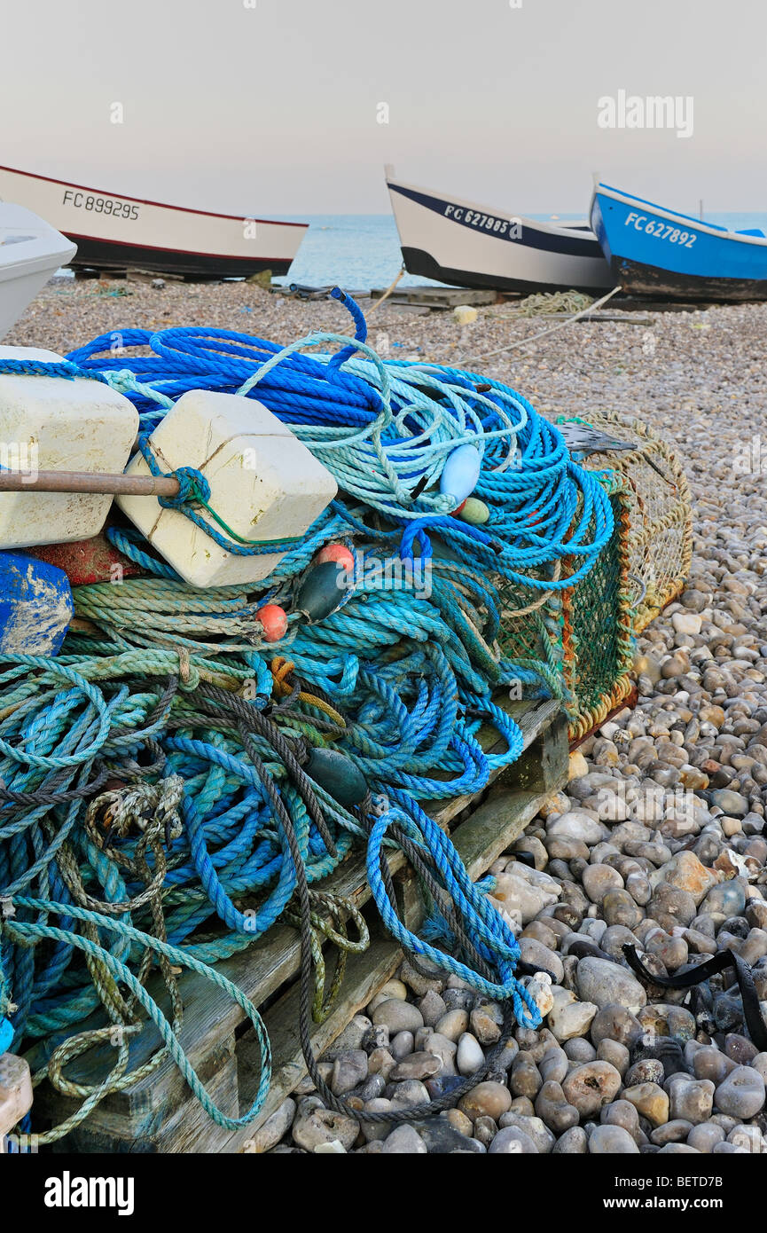 Lobster traps, ropes, floats and traditional caïques, wooden fishing boats on beach at Yport, Normandy, Côte d'Albâtre, France Stock Photo