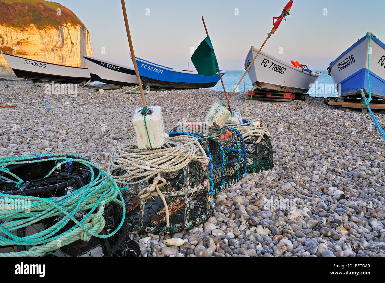 Lobster traps and colourful traditional caïques, wooden fishing boats on the beach at Yport, Normandy, Côte d'Albâtre, France Stock Photo